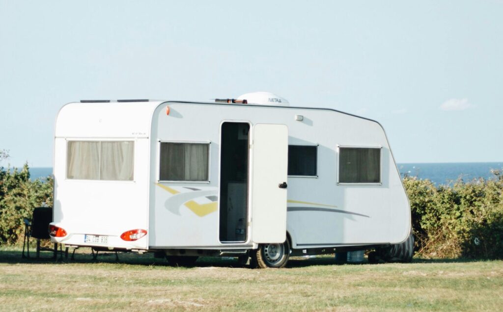 A serene campsite featuring a lone camper by the sea, perfect for outdoor getaways.